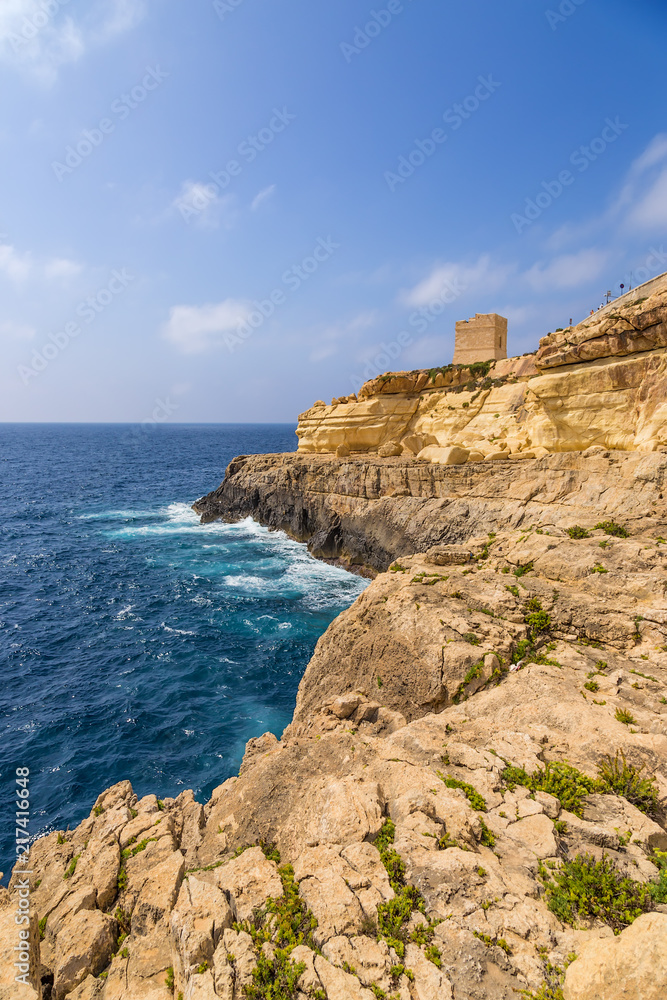 Wied Iz-Zurrieq, Malta. Scenic view with an old watch tower on a rocky shore