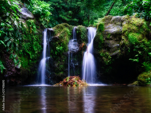Long exposure picture of a beautiful waterfall with little lake in the rain forest. long exposure