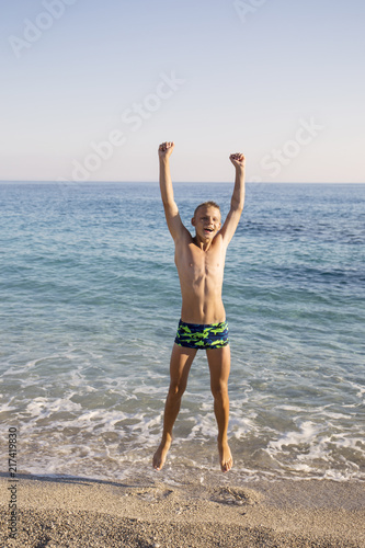 teenager jumping on the seashore.joy. fun. emotions.Summer vacation,