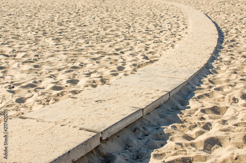 Sand beach texture. Background of sand and path swirling.