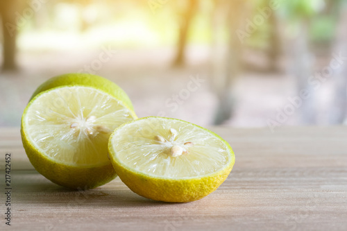Фотография Lime slices placed on wooden boards with nature background.