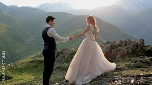 Wallpaper Mural A gorgeous red-haired bride and groom on their wedding day against the backdrop of the majestic mountains on a summer sunny day. Georgia. The concept of a happy married life Torontodigital.ca