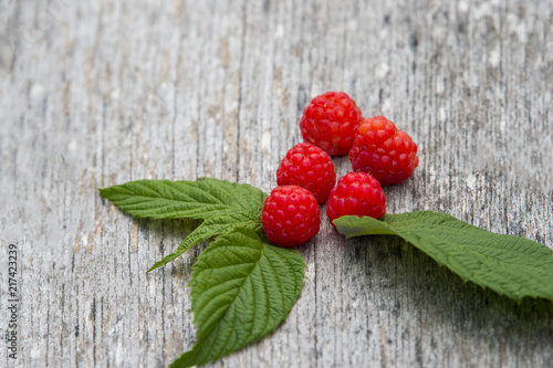 raspberries on old wooden table background. top view with copy space