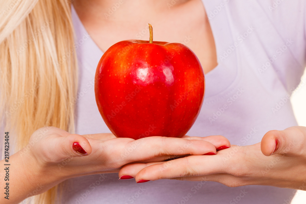 Woman hand holding red apple, healthy food concept Woman hand holding red apple, healthy food concept