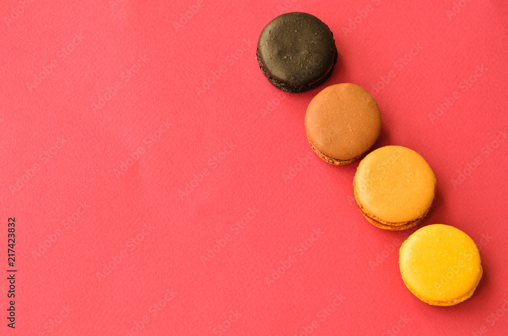 four macaroons on a pink background with a place under the text four macaroons on a pink background with a place under the text