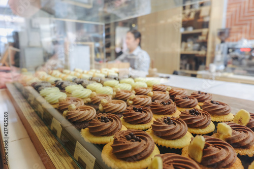 Many flavours cupcakes with testy cream on the bar