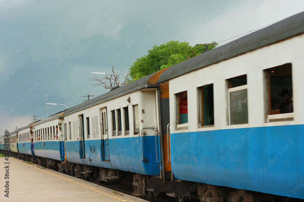 Fototapeta premium Lifestyle of People passenger travel with Rail transport in the diesel train moving at the Train station in countryside of Thailand
