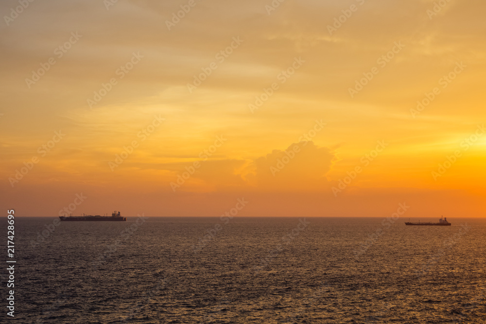Sunset at the Sea with boat and cloudy sky Sunset at the Sea with boat and cloudy sky
