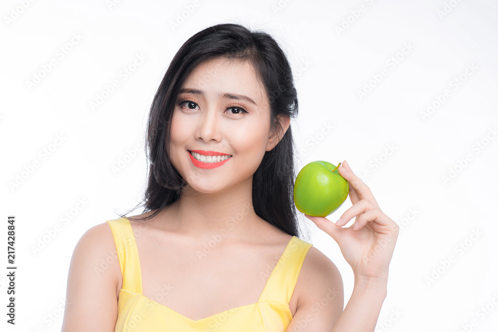 Pretty young asian woman holding fresh apple isolated on white background. Pretty young asian woman holding fresh apple isolated on white background.