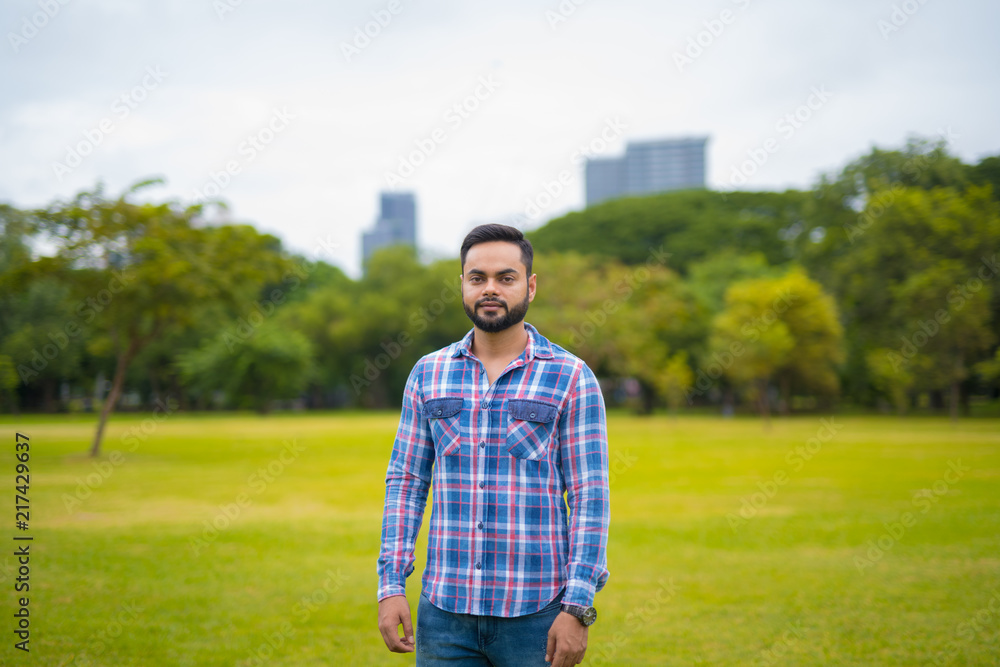 Portrait Of Young Handsome Indian Man In Park Portrait Of Young Handsome Indian Man In Park