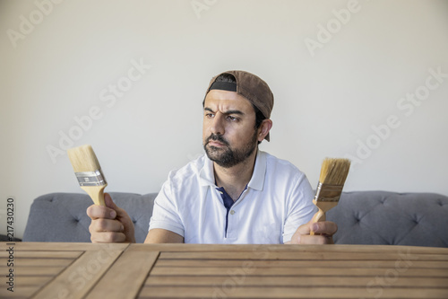 arab man renovating a wooden table photo