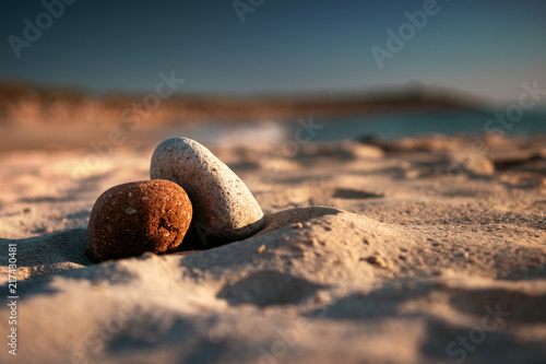 Photography Beautiful peaceful stacked zen stones chill on the sand beach at colorful sunset light
