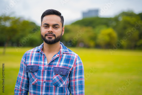 Portrait Of Young Handsome Indian Man In Park