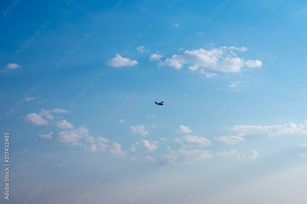 Fototapeta premium Silhouette seaplane. Flying boat on blue sky.