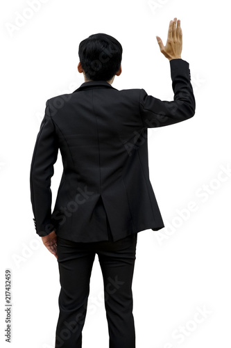 The back view of a male businessman raising his hand.