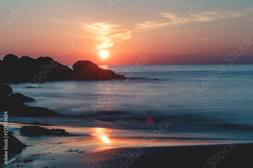 Amazing relaxing and colorful evening sunset with dramatic white clouds at a danish beach. Danish ocean sea, Lønstrup in North Jutland in Denmark, Skagerrak, North Sea