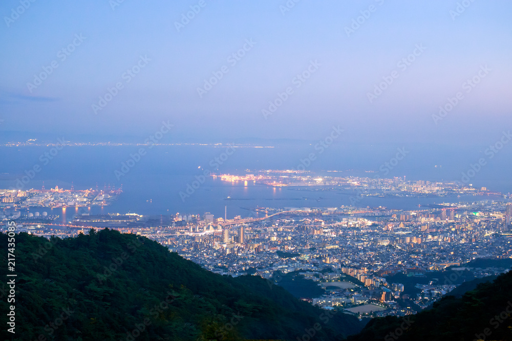 Lights from Kobe and Rokko Michi on the edge of Osaka Bay just after sunset