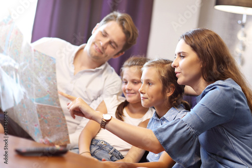 Happy family relaxing in hotel room