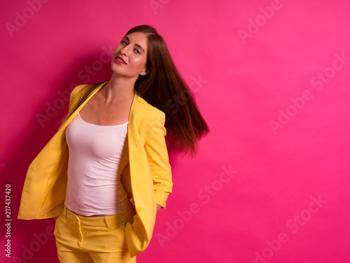 Female Model Against Pink Studio Background