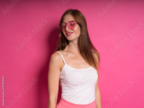 Female Model Against Pink Studio Background