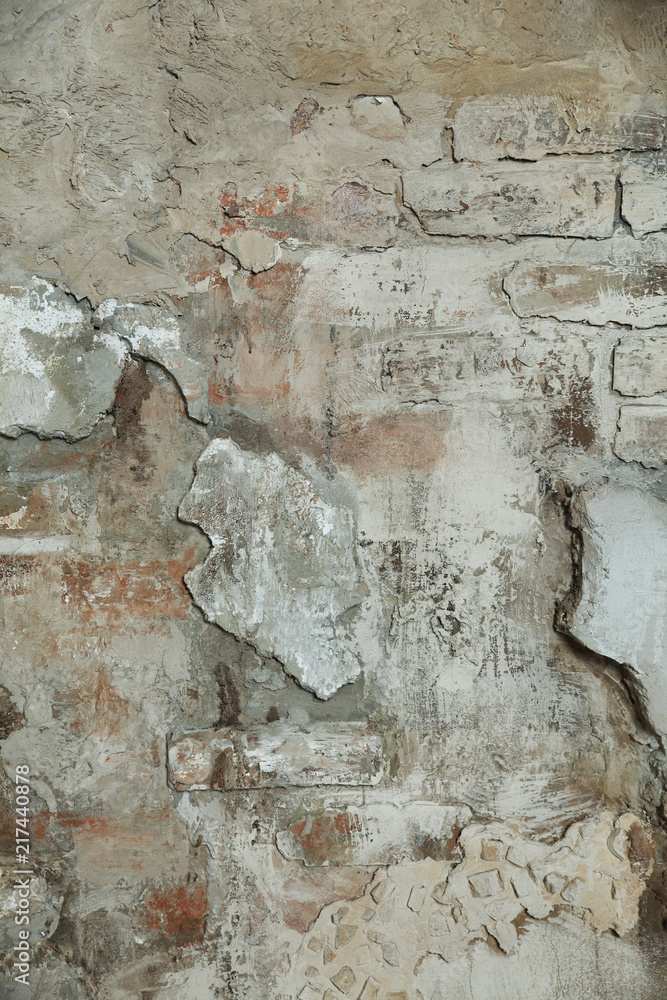 Naklejka premium Stone wall with cracks and brick