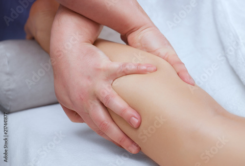 The doctor-podiatrist does an examination and massage of the patient's legs