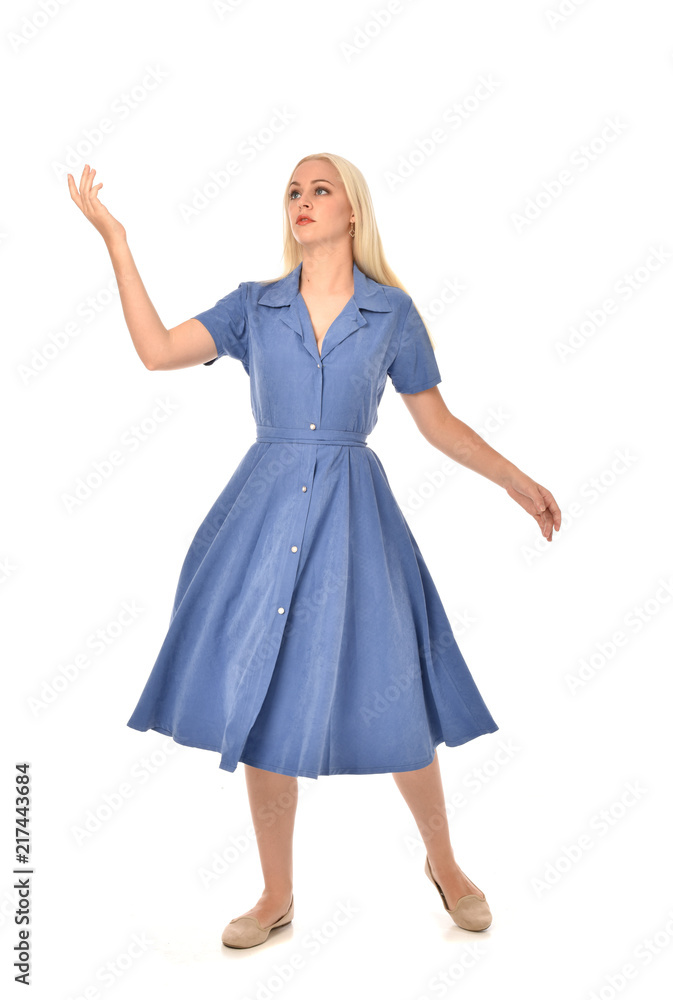 Naklejka premium full length portrait of blonde girl wearing blue dress. standing pose. isolated on white studio background.