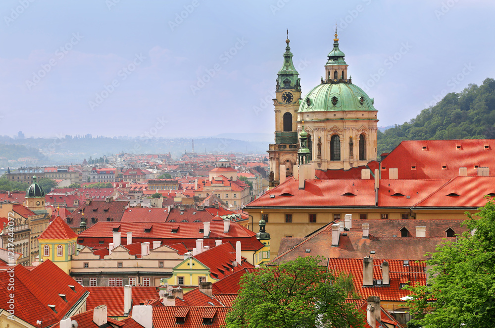 St Nicholas Church dome above red roof tops of Mala Strana, Prague, Czech Republic