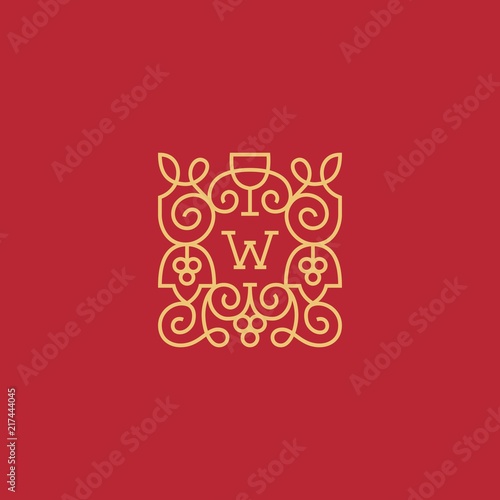 Gold monogram of grapes on a red background.