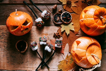 marshmallow stylized to celebrate halloween on a pumpkin background