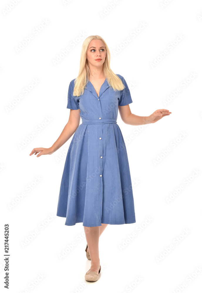 full length portrait of blonde girl wearing blue dress. standing pose. isolated on white studio background. full length portrait of blonde girl wearing blue dress. standing pose. isolated on white studio background.