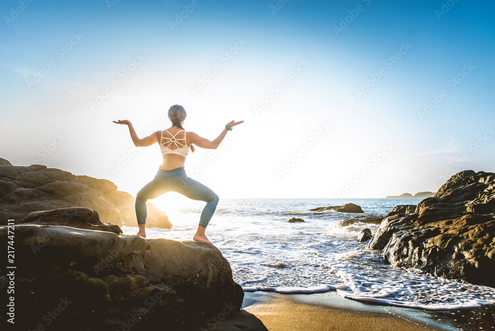 Woman doing yoga on the beach Woman doing yoga on the beach