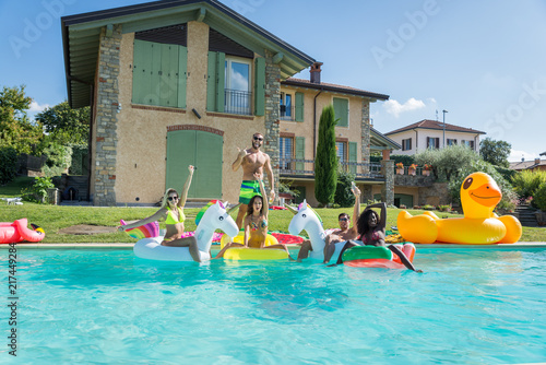 Friends having fun in a swimming pool © oneinchpunch