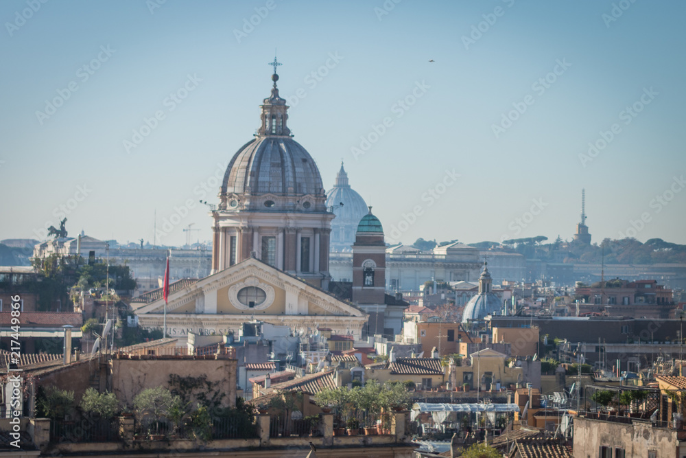 The domes and rooftops of the eternal city, the view from the Spanish steps, Rome, Italy, sunny day and blue sky
