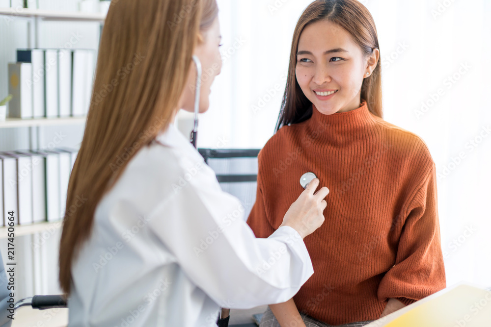 Fototapeta premium asian woman doctor Breast cancer Symptoms, risk factors, and treatment checking for patient in clinic office