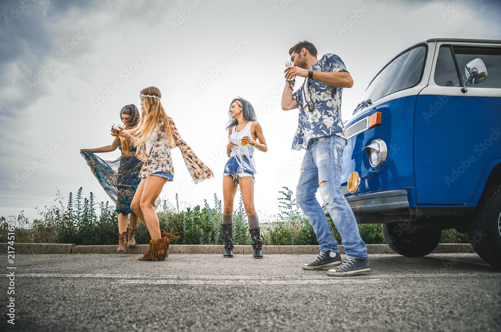 Obraz premium Happy friends driving a vintage minivan