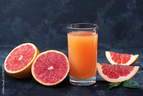 Glass of  grapefruit juice on on a black background