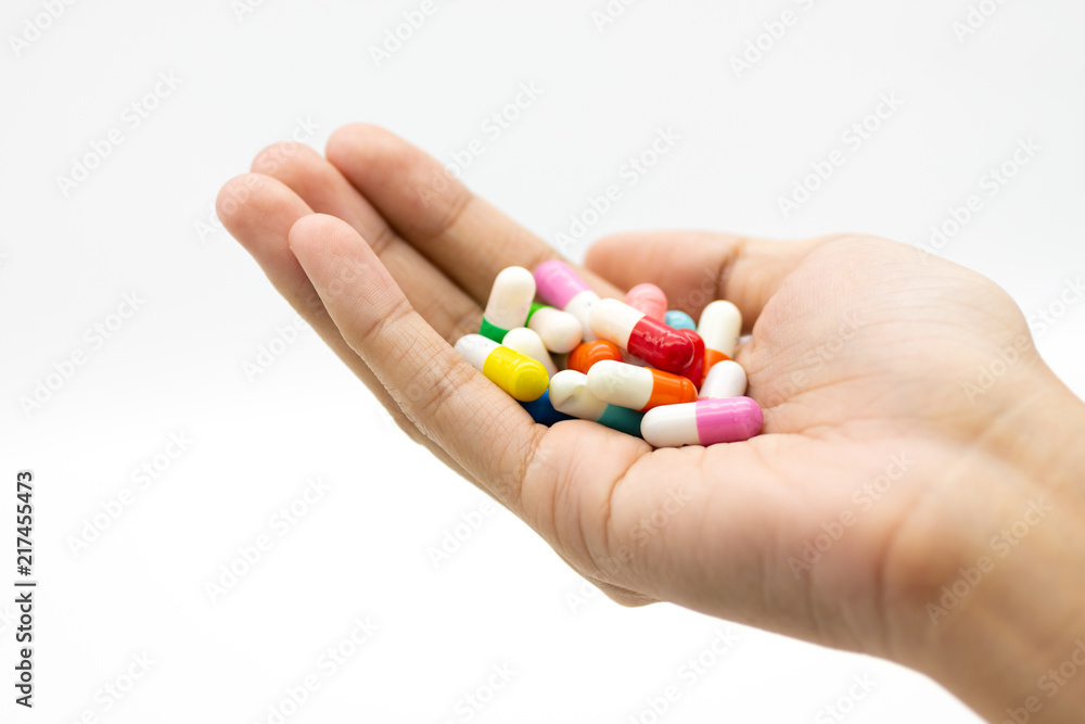 Colorful capsules tablets hold on hand. Image use for health care concept Colorful capsules tablets hold on hand. Image use for health care concept