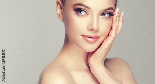 Beautiful Young Woman with Clean Fresh Skin look away .Girl beauty face care. Facial treatment . Cosmetology , beauty and spa . 
