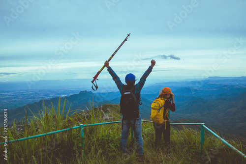 Lover woman and man Asian travel nature. Travel relax. Walk study the path Nature in the forest photo