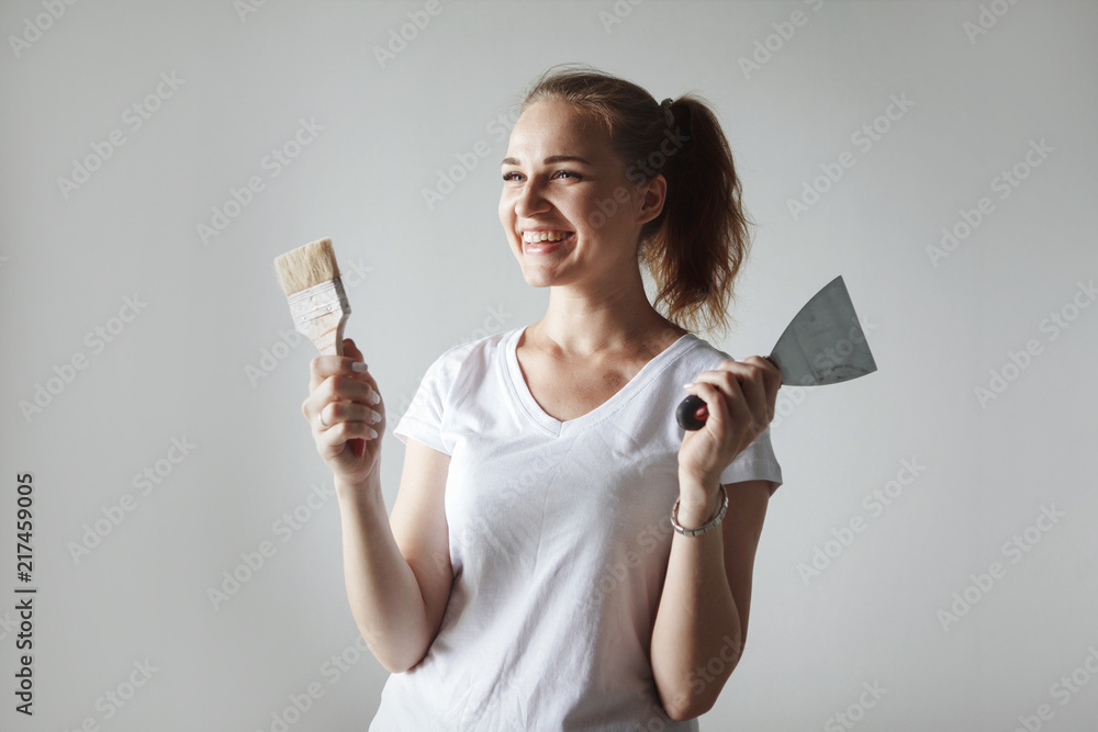 The girl is doing repairs in the apartment. The girl is doing repairs in the apartment.