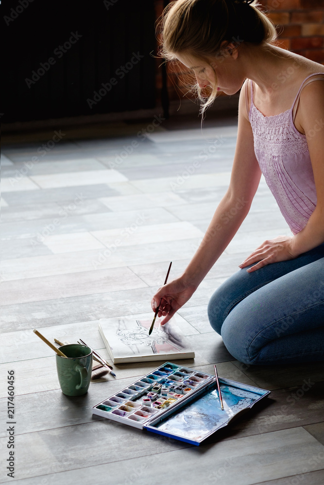 creative leisure. painting hobby. artful personality. talented girl drawing a picture sitting on the floor. creative leisure. painting hobby. artful personality. talented girl drawing a picture sitting on the floor.