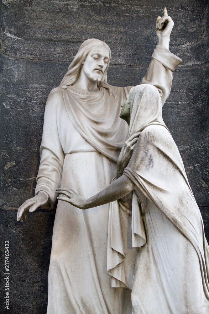 Milano, Italy. 2018/2/8. A statue of the encounter of risen Jesus Christ and Mary Magdalene on a tombstone at the Cimitero Monumentale (