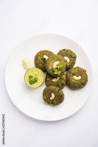 Hara bhara Kabab or Kebab is Indian vegetarian snack recipe served with green mint chutney over moody background. selective focus photo