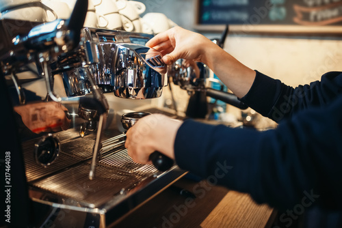 Barista hand pours beverage from coffee machine