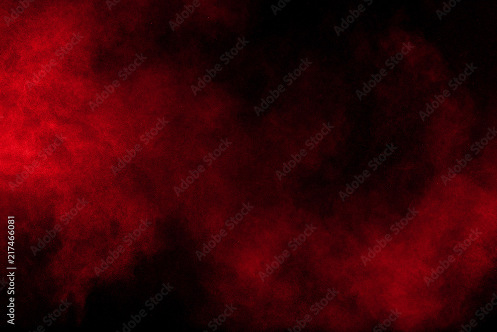 Abstract explosion of red powder on black background Freeze motion of red powder splash.