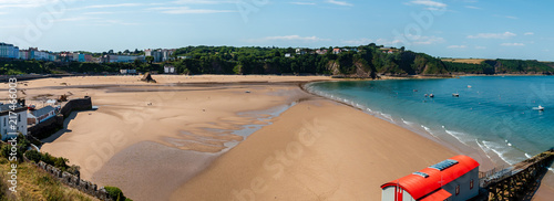 Panoramic view of a huge empty sandy beach at low tide on a sunny, summers day (Tenby)