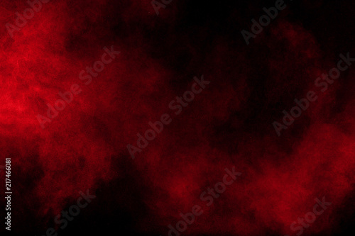 Abstract explosion of red powder on black background Freeze motion of red powder splash.