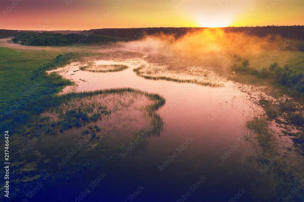 Early misty morning, wilderness. Aerial view of countryside and river