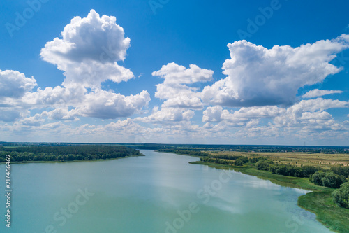 Aerial view of the countryside and the river. Blue sky with beautiful clouds